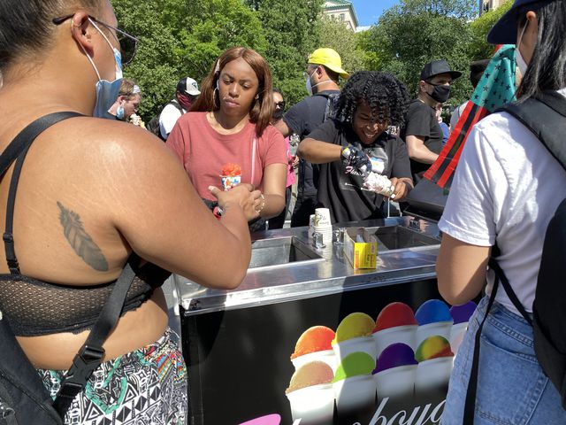 Vendor gives away free ices to protesters at Washington Square Park.